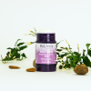 Geöffneter INUANA Deo Stick Magnesium Active Blooming Musk mit Jasminblüten und Mandeln auf hellem Hintergrund.