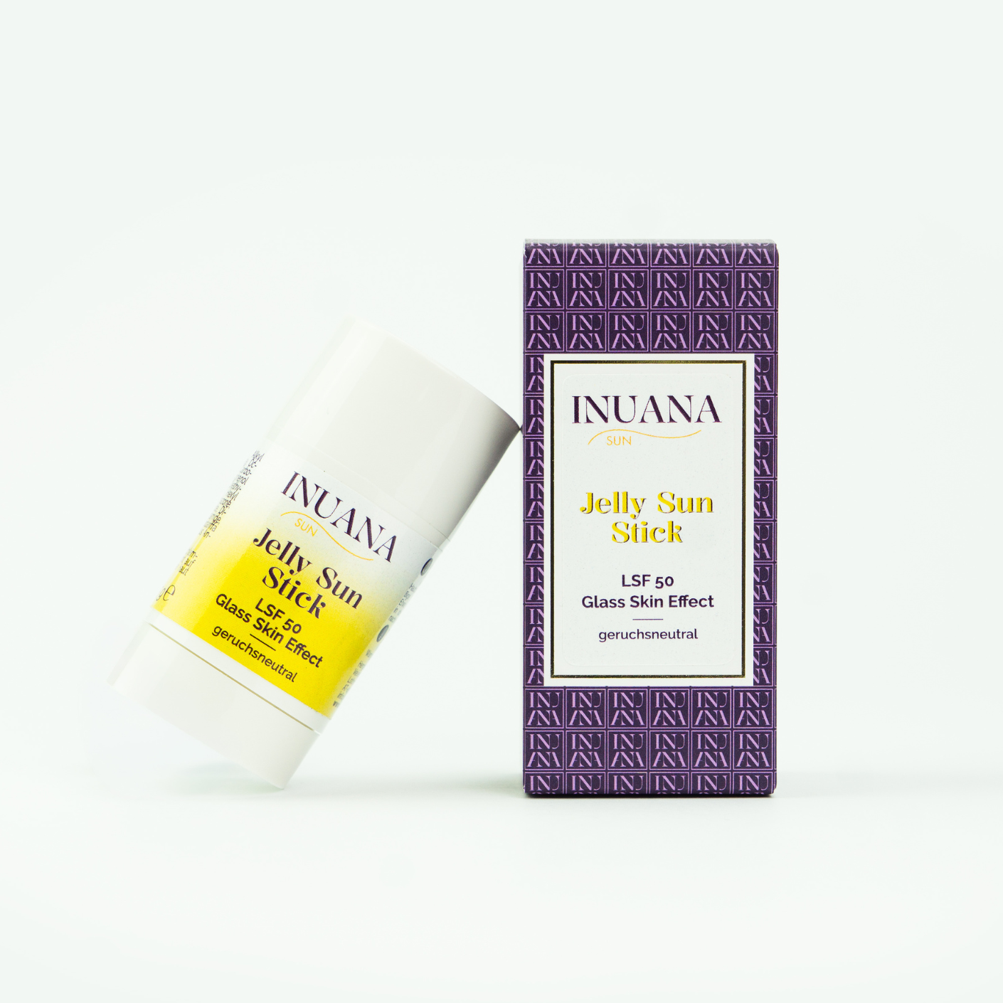 INUANA SUN Jelly Sun Stick LSF 50 im weißen Kosmetik Stick neben der violett gemusterten Karton-Verpackung.
